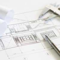 Construction plans and drawing tools on blueprints